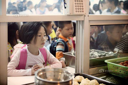 Cô bé Khoáng Vũ Hân nhỏ tuổi đã biết tự lấy cơm trước khi lên lớp.